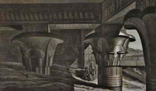 quietly two men sit below the giant pillars of Edfu temple.